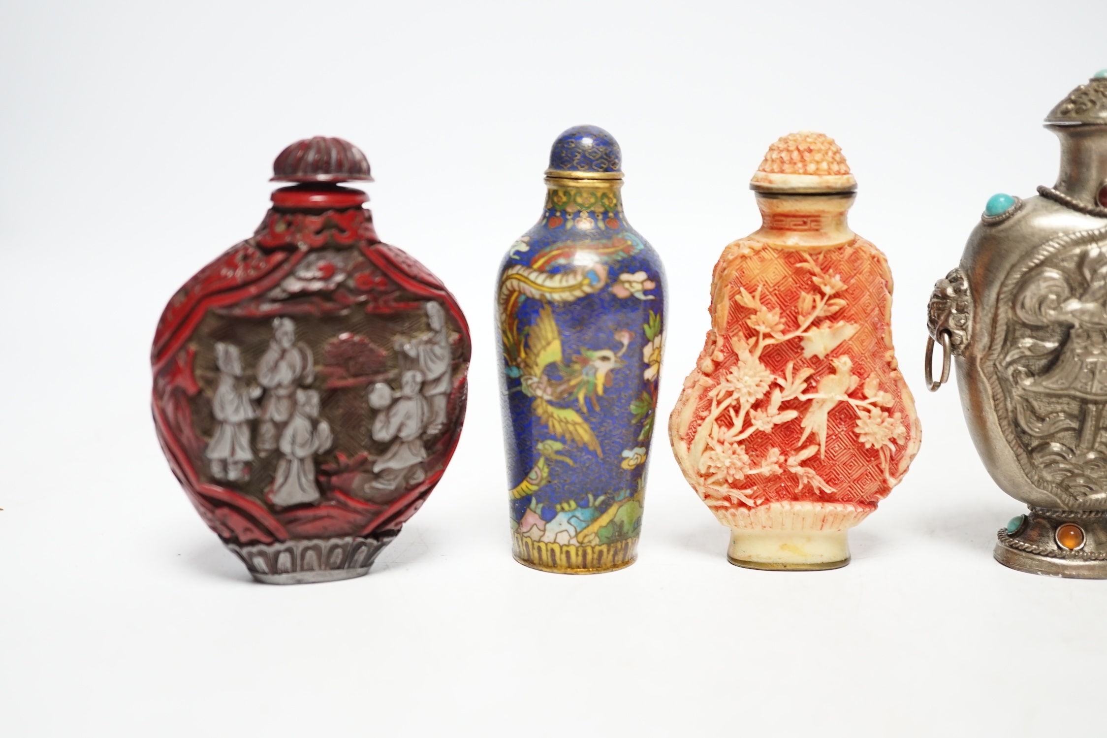 A Chinese cloisonné enamel snuff bottle, two resin snuff bottles, a carved mother of pearl snuff bottle and a Tibetan style metal snuff bottle, largest 8.5cm high